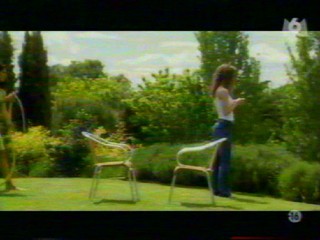 Two girls playing with a waterhose.