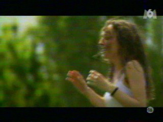 Two girls playing with a waterhose.