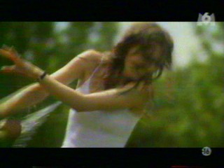 Two girls playing with a waterhose.